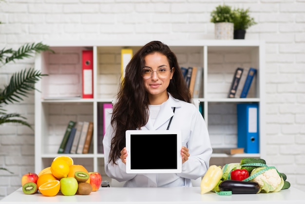 Free photo medium shot young doctor with tablet mock-up