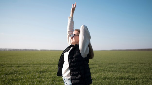 Medium shot of young girl in the field