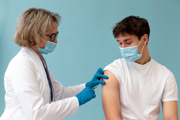 Medium shot young man getting vaccine