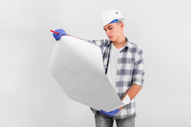 Medium shot of  young man looking at plan