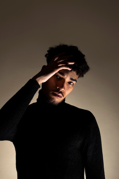 Medium shot young man posing in studio