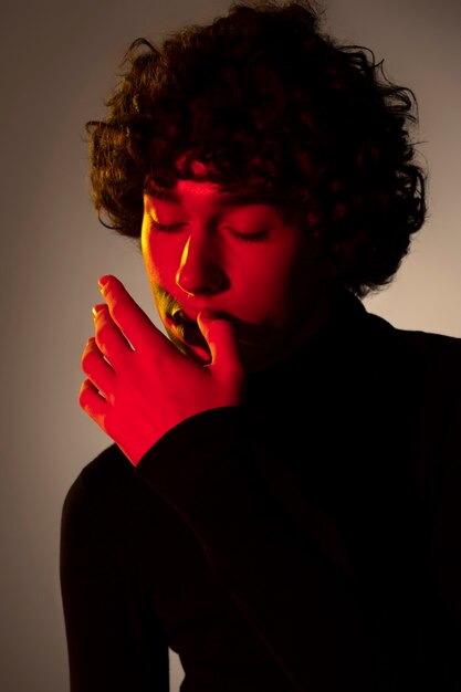 Medium shot young man posing in studio