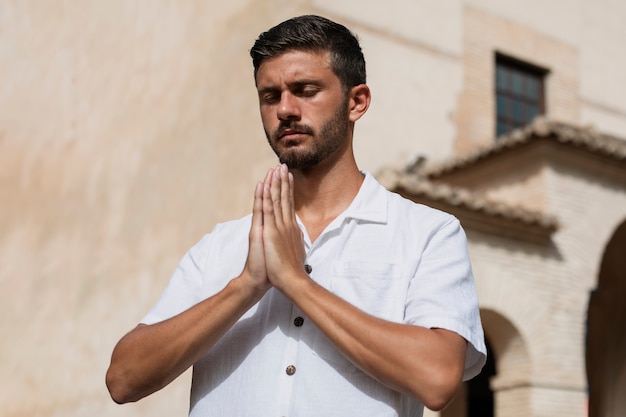 Medium shot young man praying