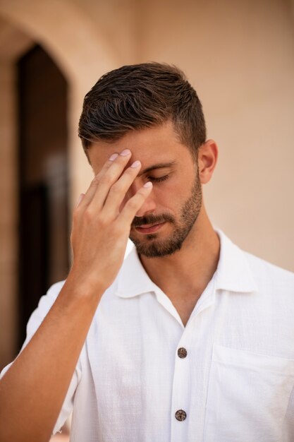 Medium shot young man praying