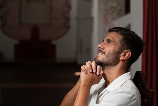 Free photo medium shot young man praying