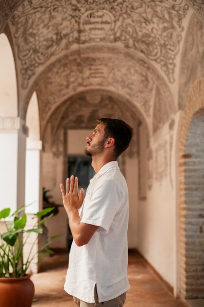 Medium shot young man praying