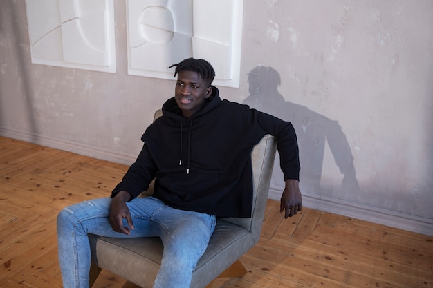 Medium shot young man sitting on chair