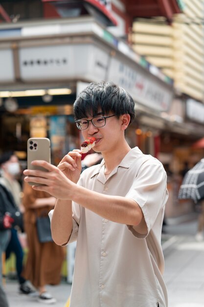 Medium shot young man taking selfie