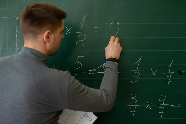 Medium shot young man teaching math