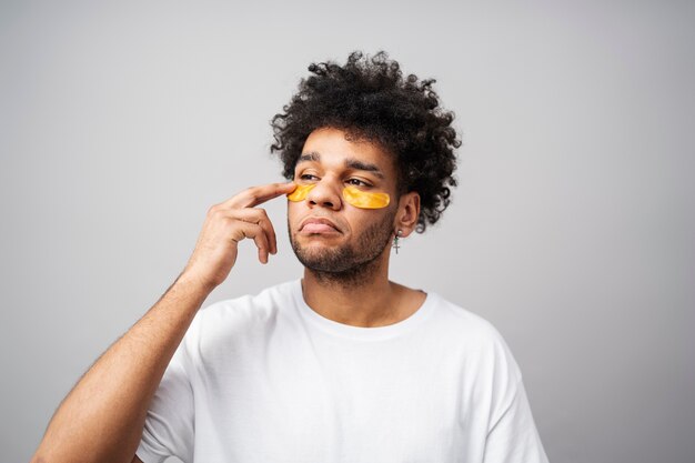 Medium shot young man wearing eye patches