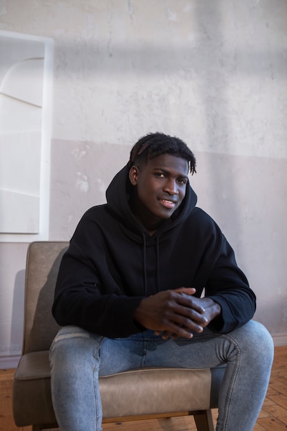 Free photo medium shot young man wearing hoodie