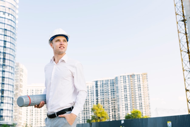 Medium shot young man with helmet looking away