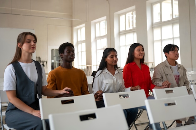 Free photo medium shot young people at church praying