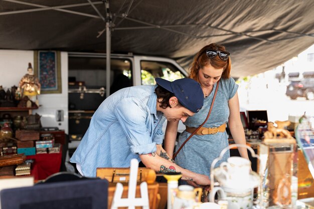 Medium shot young people at flea market