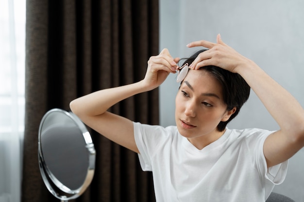 Medium shot young woman doing skincare Free Photo