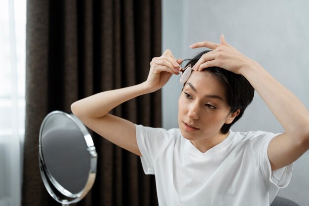 Medium shot young woman doing skincare