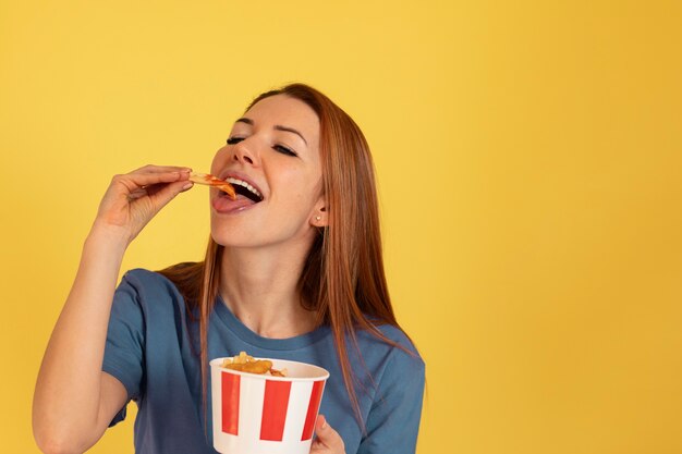 Medium shot young woman eating fast food