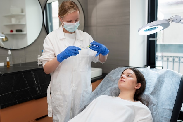 Free photo medium shot young woman getting prp treatment