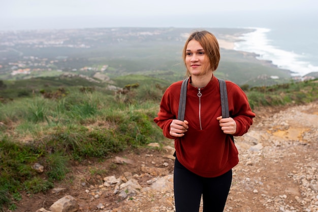 Medium shot young woman hiking