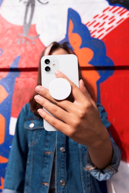medium shot young woman using popsocket
