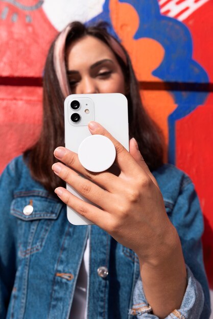 medium shot young woman using popsocket