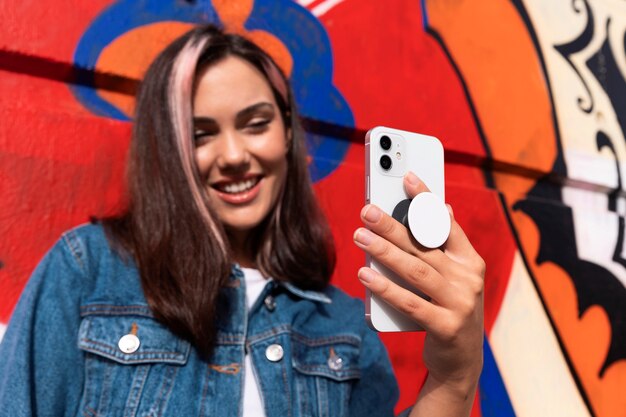 medium shot young woman using popsocket