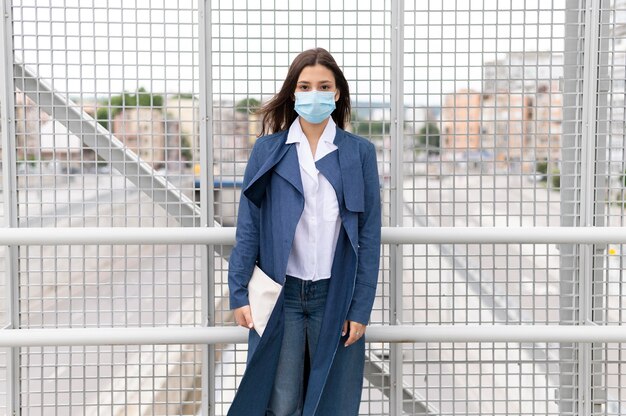 Medium shot young woman wearing face mask