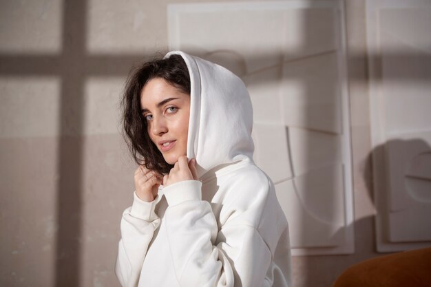 Medium shot young woman wearing hoodie