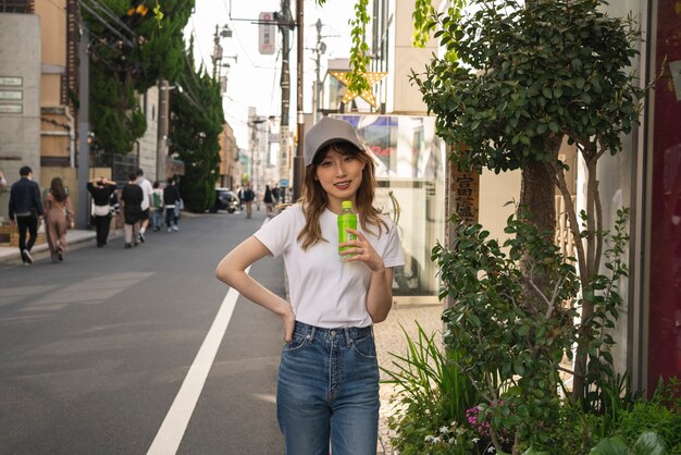 Medium shot young woman with trucker hat outdoors