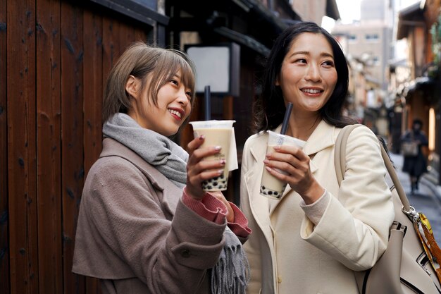 Medium shot young women with bubble tea