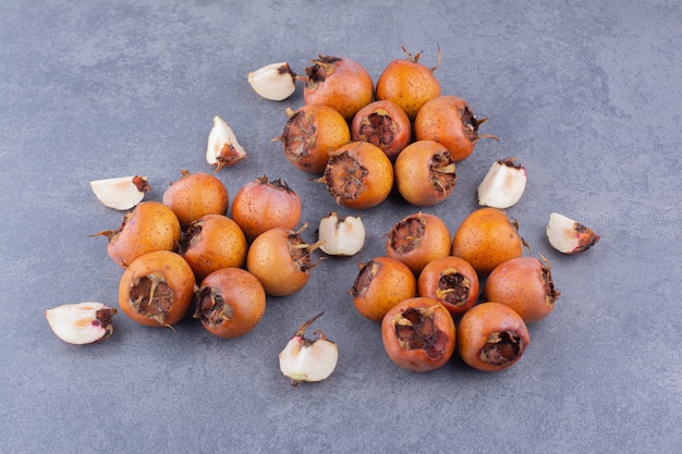 Medlars isolated on the blue concrete surface