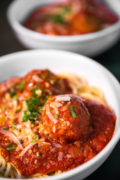 Meetballs with noodles served on white ceramic bowl