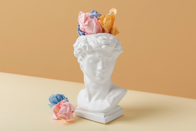 Memory concept with sculpture and paper still life
