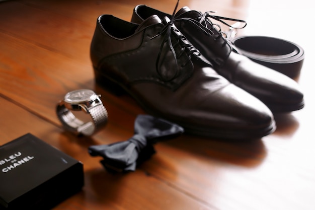 "Men accessories laid out on wooden floor"