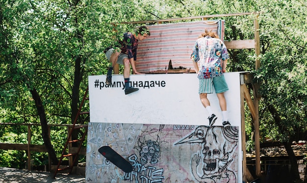 Men climbing on ramp in skatepark