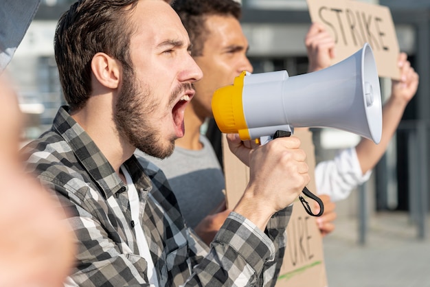 Men demonstrating together with megaphone