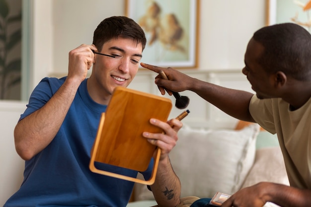 Free photo men doing makeup indoors