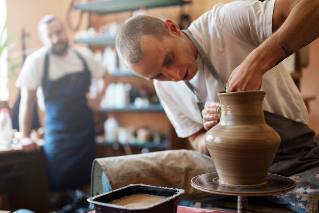 Men doing pottery medium shot