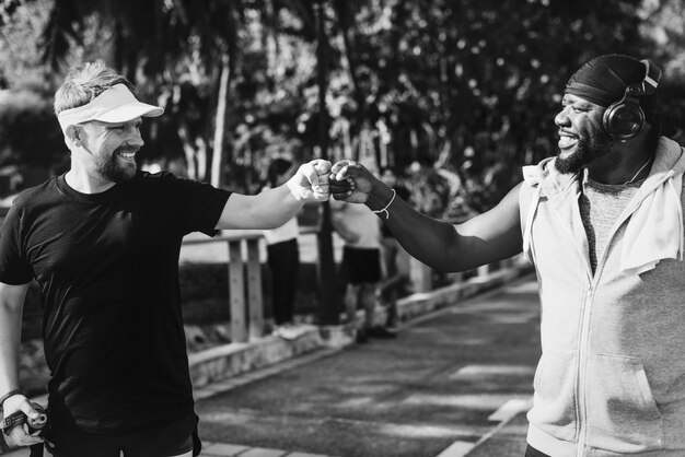 Men giving a fist bump while jogging