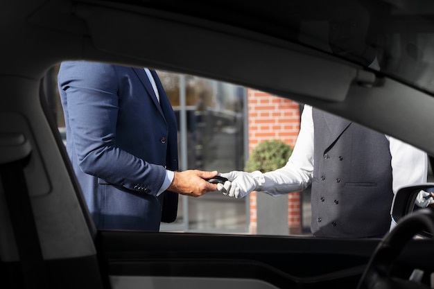 Free photo men holding car key side view