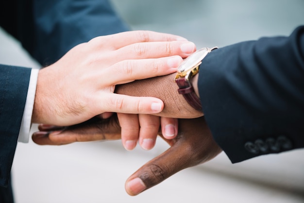 Men holding hands together