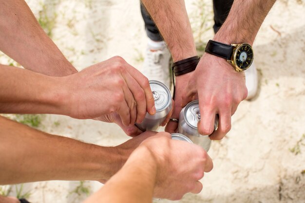 Men opening beer cans