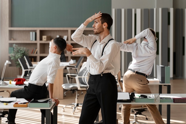 Men performing vogue dance indoors