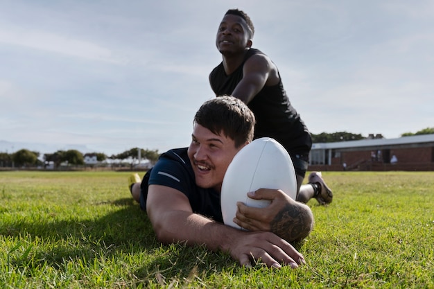 Men playing rugby on the field