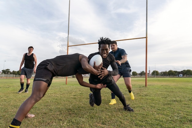 Men playing rugby on the field