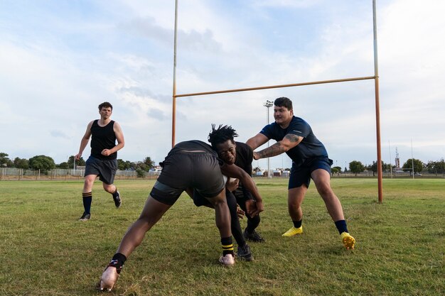 Men playing rugby on the field