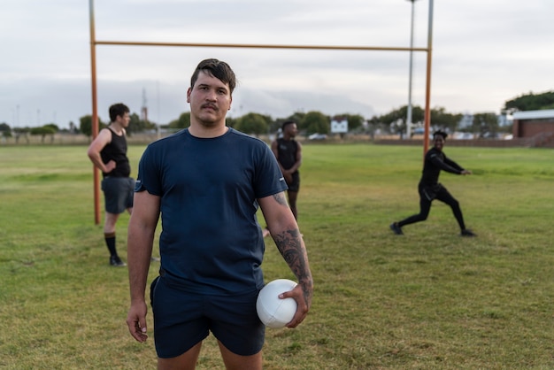 Men playing rugby on the field