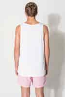 Free photo men’s white tank top and pink shorts for teen’s summer apparel shoot with design space