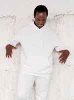 Free photo men’s fashion hoodie on man with concrete wall
