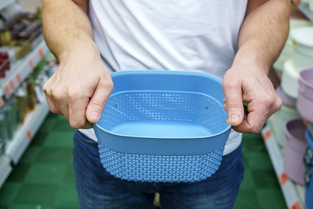 Free photo men's hands hold a plastic box basket